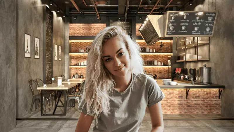 A women sitting with a living room background behind her