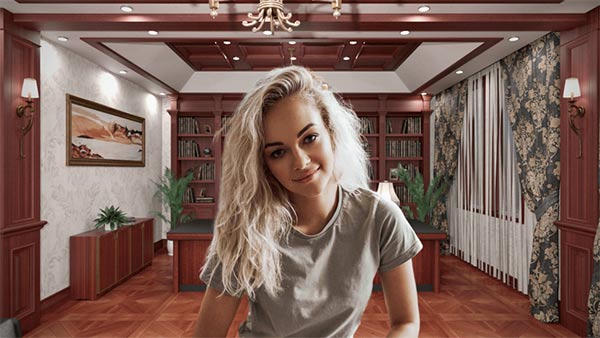 This picture showcases a woman with blonde hair sitting in front of a brown cupboard