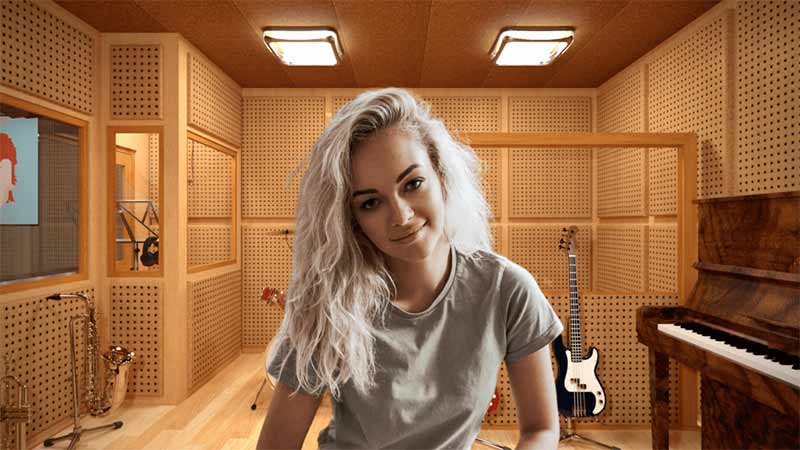 The picture showcases a women sitting before a Recording Studio background
