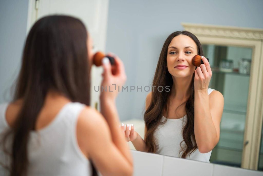 stock photo of a woman doing makeup