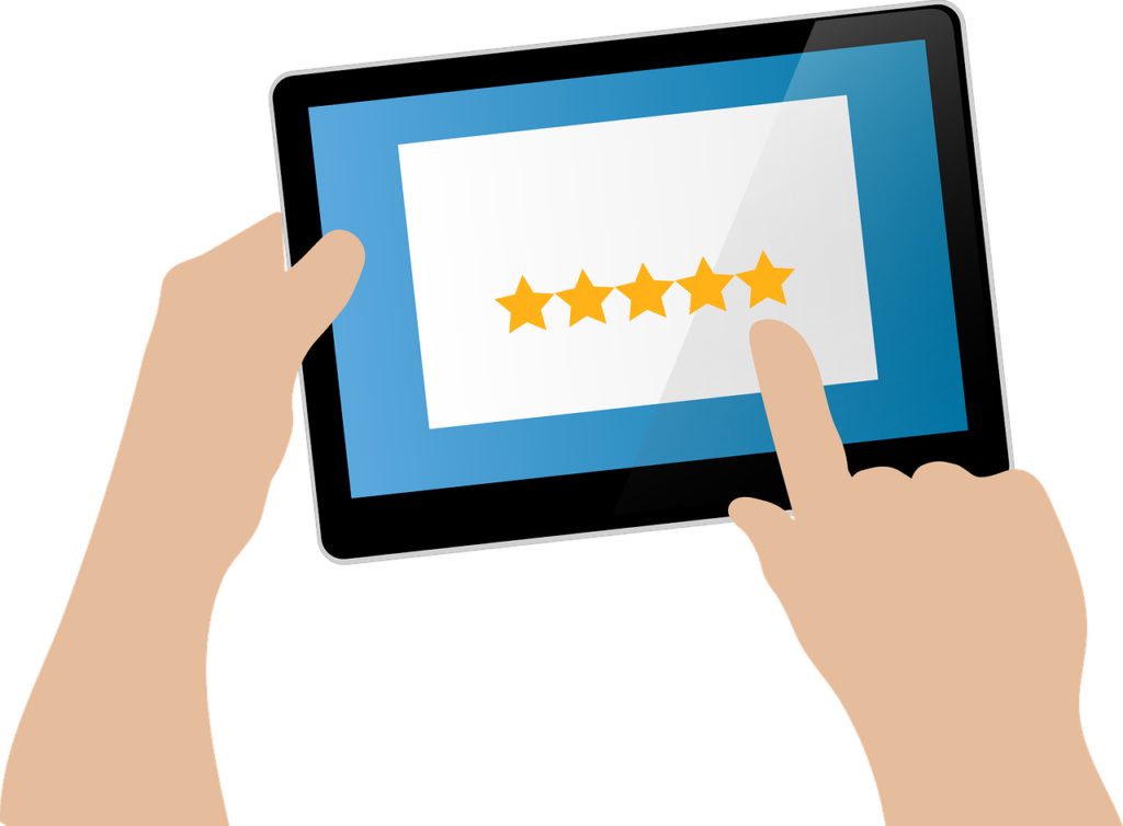 A person giving a five-star rating on a tablet.