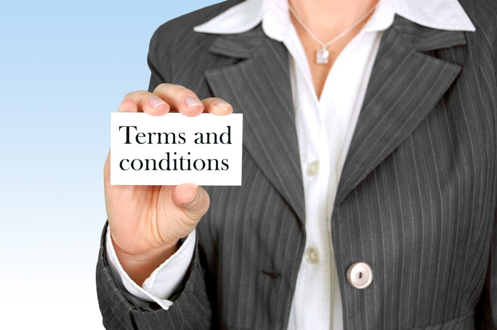 woman holding a card that says terms and conditions.
