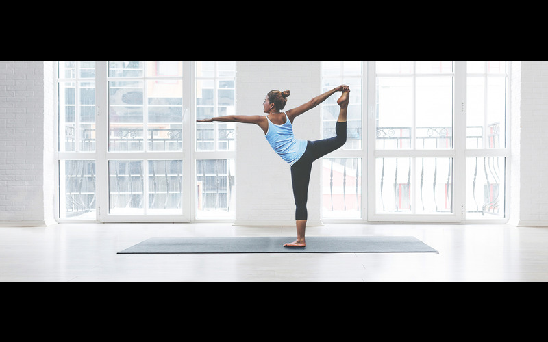 A woman doing yoga in a room