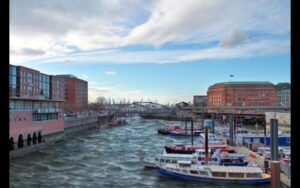 A dock with boats and buildings in the background after using HDR 9 Pro - Photo Editing Software