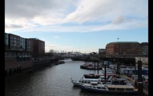 A dock with boats and buildings in the background converted with best hdr software for real estate photography