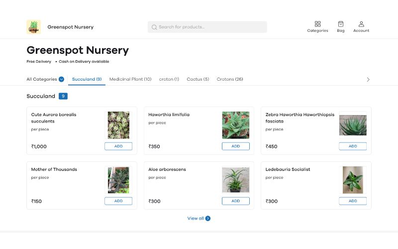 Several plants on display in the window of a site involving plant nursery