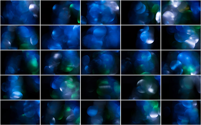 "Green and blue orbs of light intermingling in a captivating bokeh symphony."