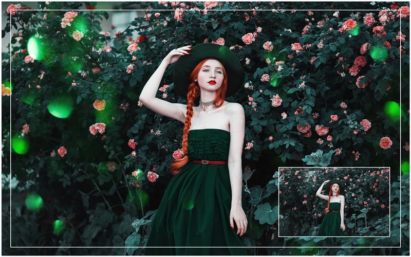 a girl in a dark green dress with ginger hair standing in front of a flower plant bush