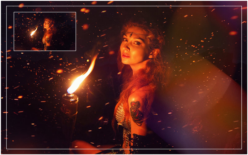 image of a lady holding fire close to her face lighting up the surrounding