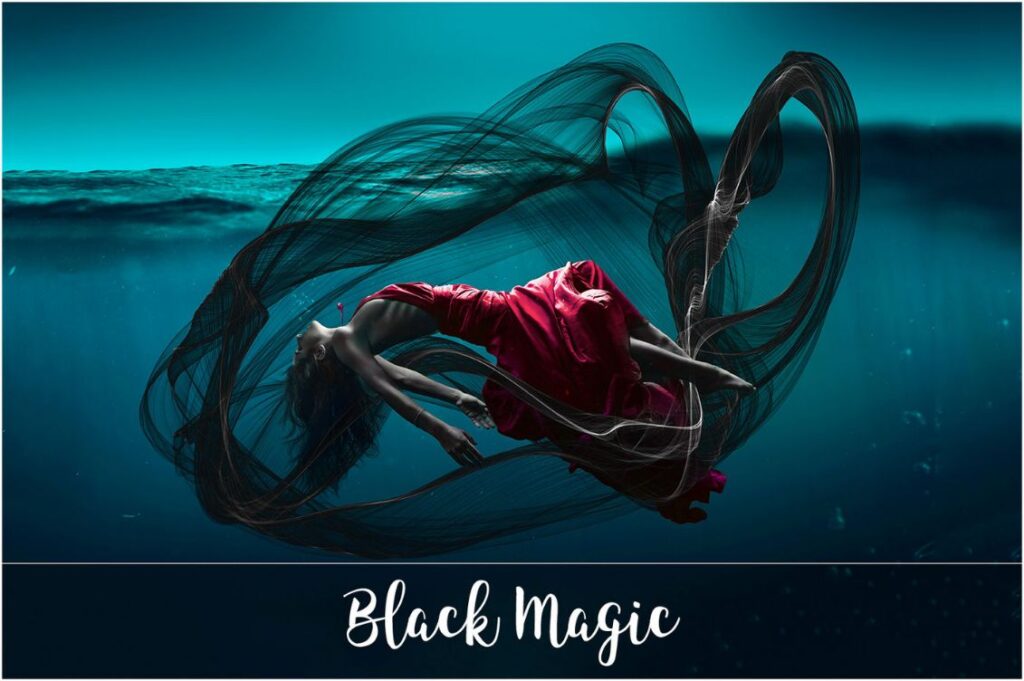 Girl in red dress Submerged in water with black wave like patterns around her.