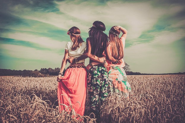 a picture of three woman in a field