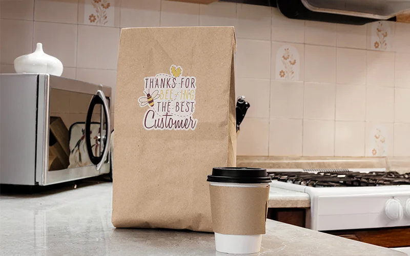 takeaway coffee cup and paper bag mockup on top of a kitchen counter