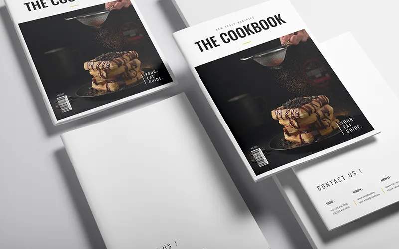 Angled side view of cookbook cover featuring stacked pancakes with syrup and powdered sugar.