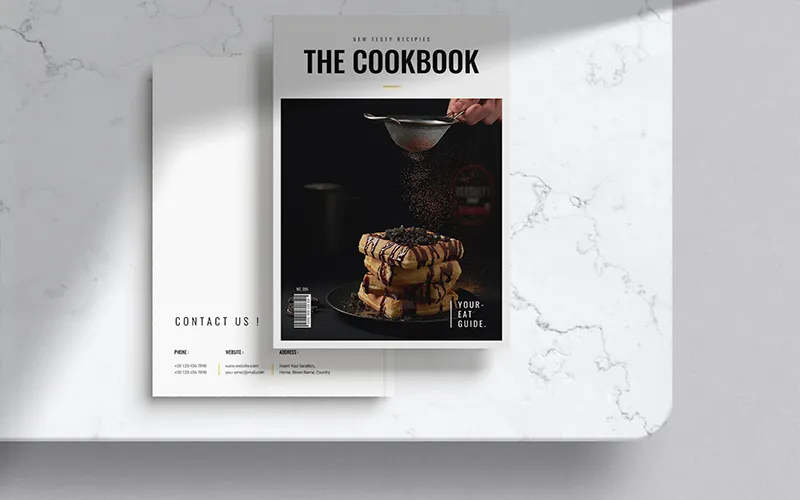 Top-down view of a cookbook showing contents page with food.