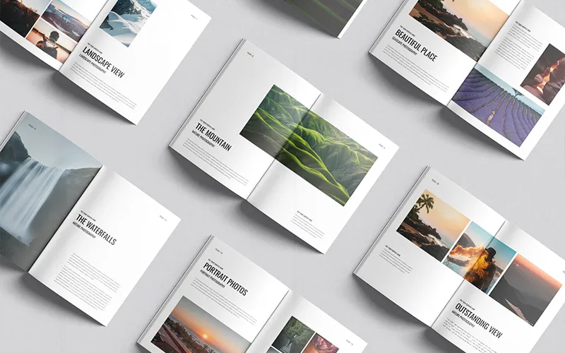 Collection of open white photography portfolio books, showcasing diverse landscape and portrait photography.
