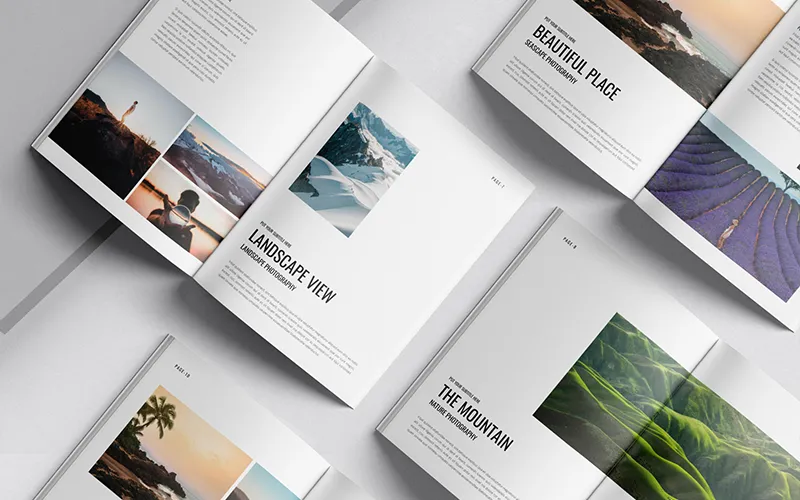 White photography portfolio book with a desert landscape on the cover, on a marble surface.