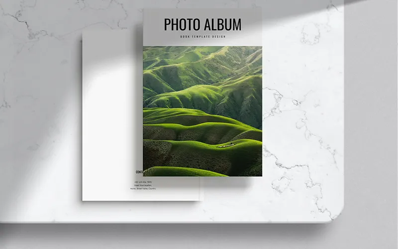 Photo album with green hills cover on marble