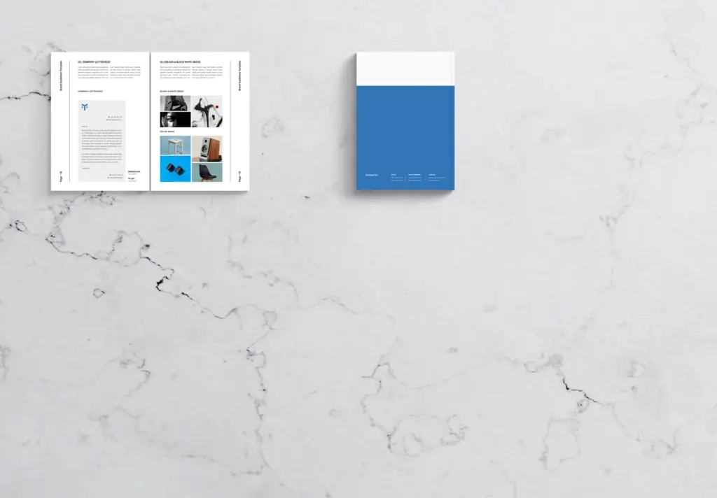 Open spread of the brand guidelines on a marble surface, showing the Company Letterhead and Color & Black/White Image usage sections, next to a closed cover.