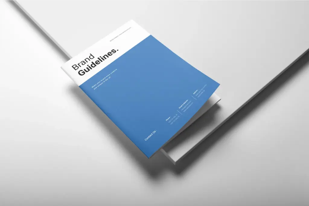 Angled mock-up of the brand guidelines cover, featuring the blue and white design with contact information.