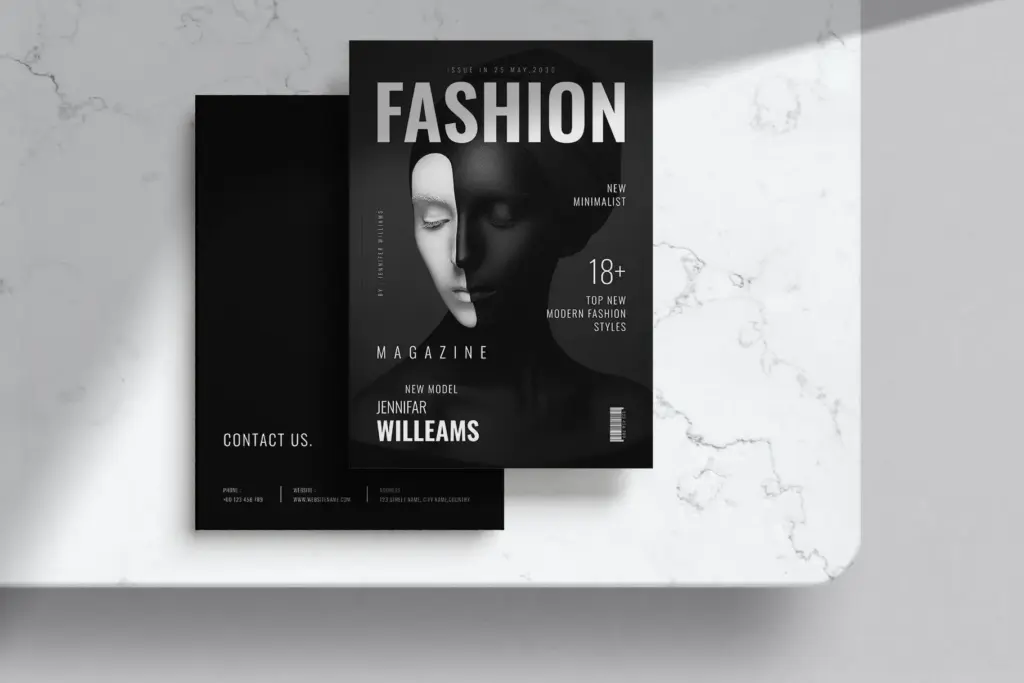 Black-and-white fashion cover with dramatic lighting and contact info.