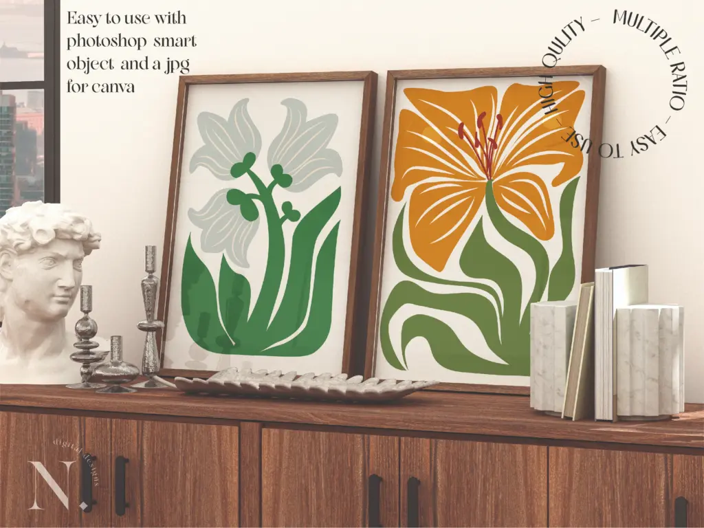 Two framed floral art prints in yellow and green and white and green displayed on a dark wood cabinet with a classical bust and candlesticks.