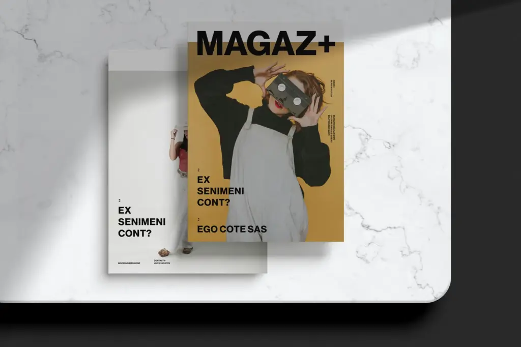 Two MAGAZ+ covers on marble—one bold yellow, one white—both featuring VR headset imagery.