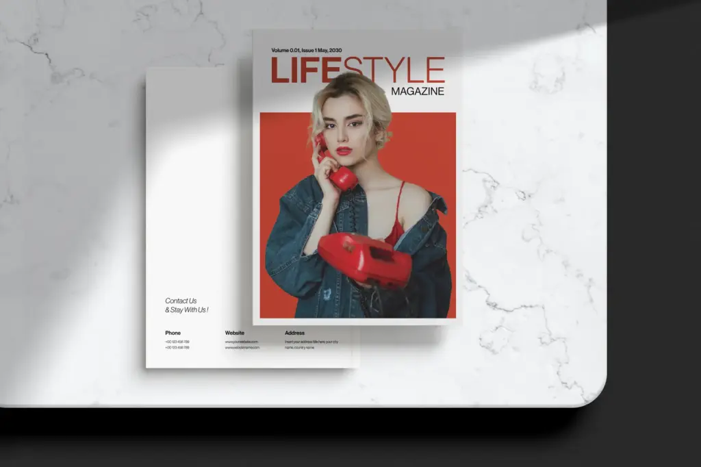 Red-themed lifestyle cover with contact card on marble.