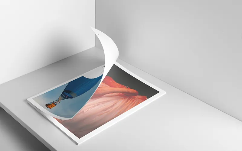 Minimal art print stack showing a hot air balloon and abstract orange fabric beneath