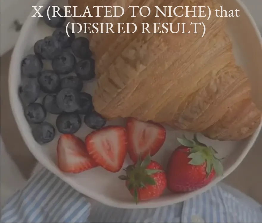 Overhead view of a plate with a croissant, strawberries, and blueberries.