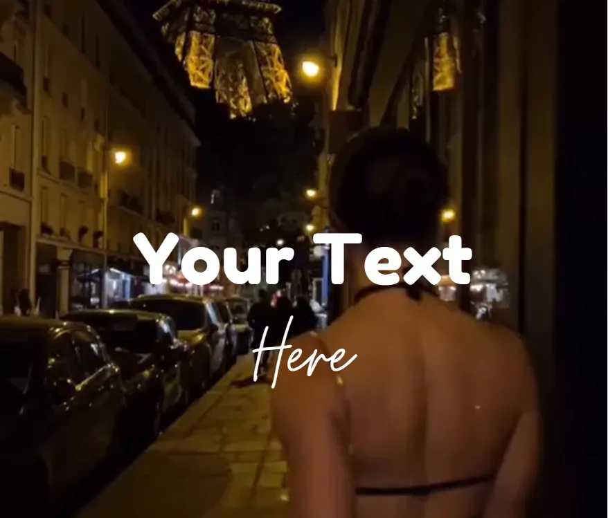Woman walking down a Paris street at night with the lit Eiffel Tower in the background.