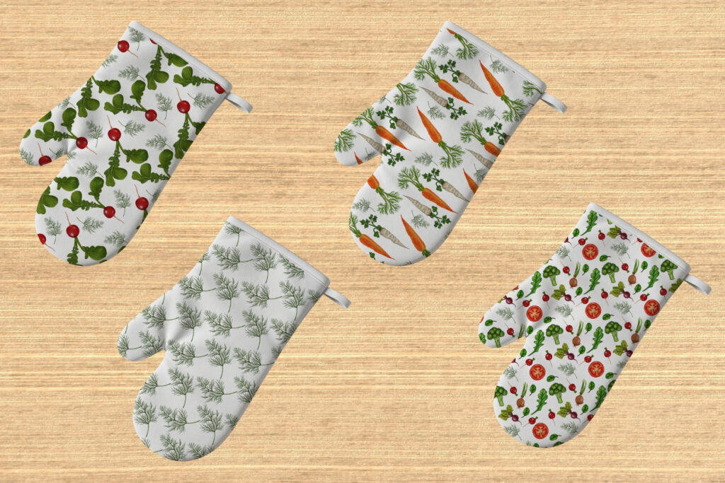 Four oven mitts with vegetable prints including radishes, dill, and leafy greens