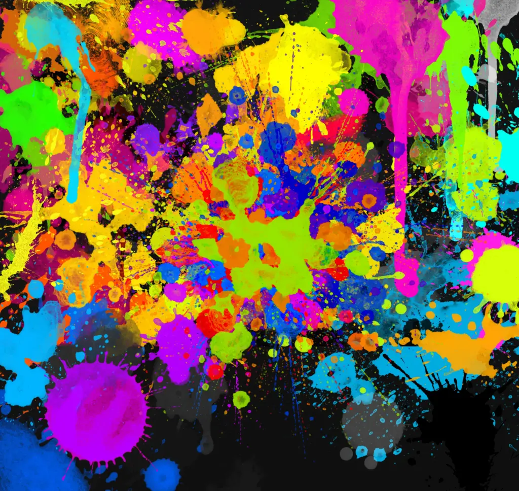 Abstract explosion of neon paint splatters on black background, evoking energy and spontaneity.